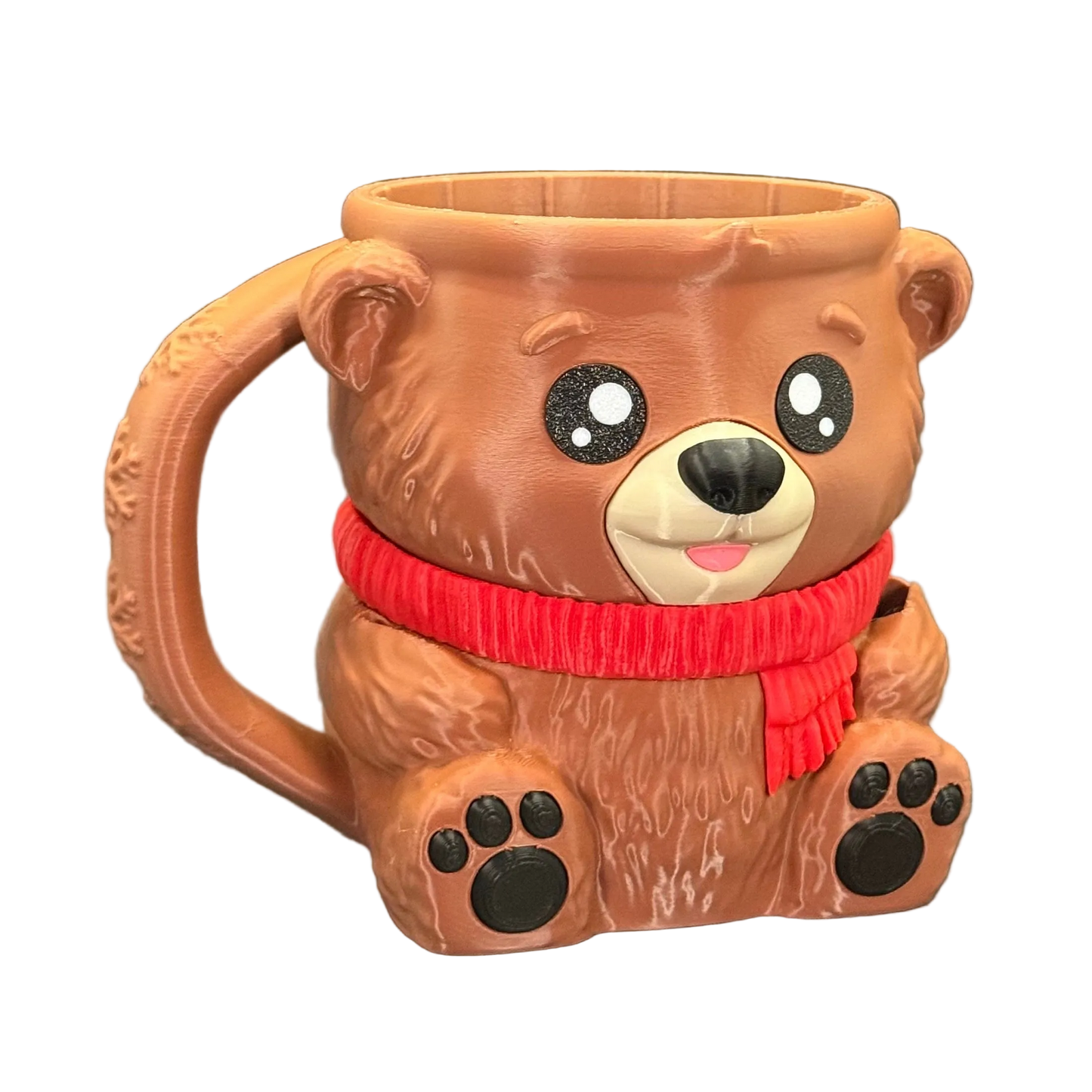 Bear-shaped mug with a red scarf on a white background