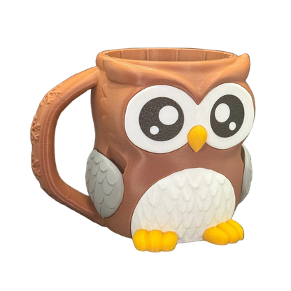 Owl-shaped mug with a brown body, white face, and yellow beak on a white background